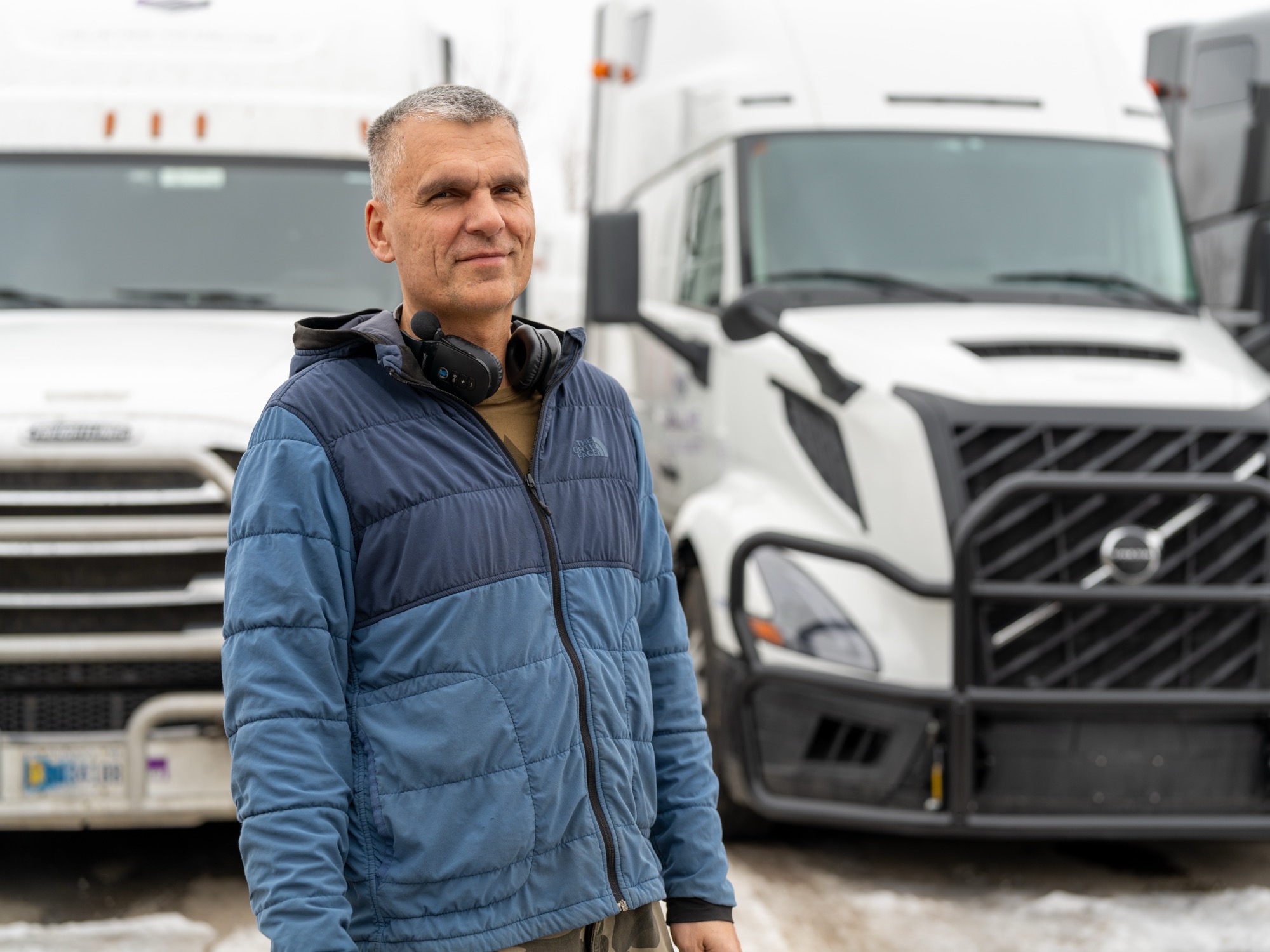 MDX Line driver in front of branded Volvo truck